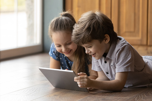 two kids looking at a tablet