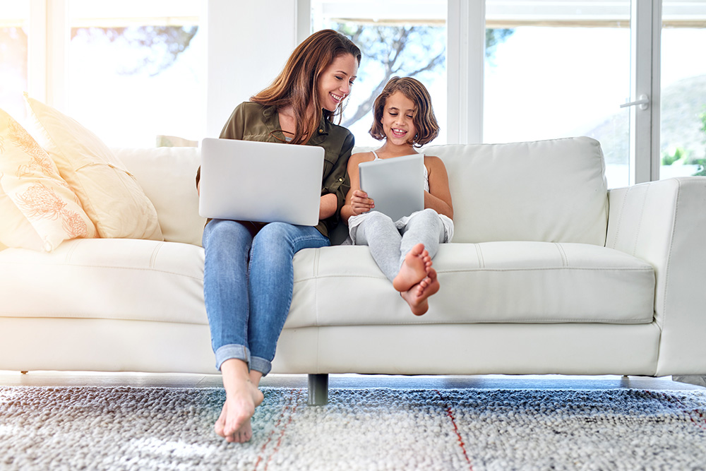 mom and daughter looking at tablets