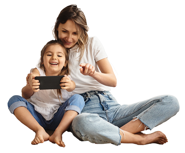 Mother and daughter laughing while watching a tablet together