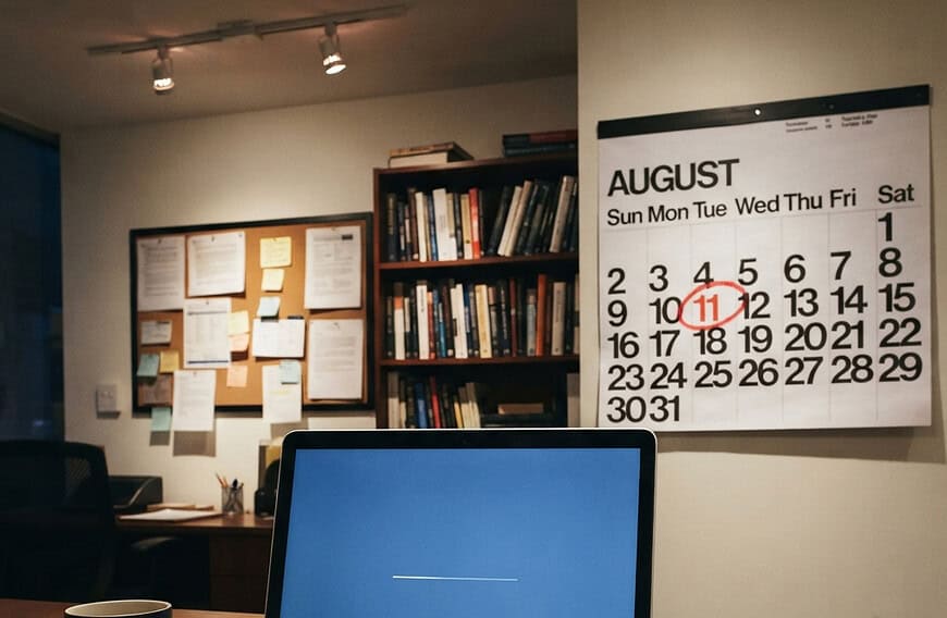 Laptop installing Windows updates beside a calendar with the second Tuesday circled in red, showing what is Patch Tuesday